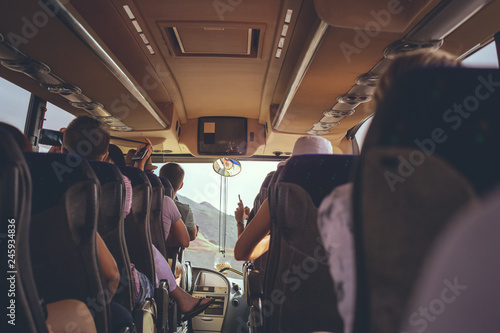 The tourist bus interior with people sitting