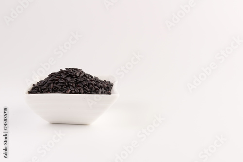 bowl of black wild rice isolated on white background