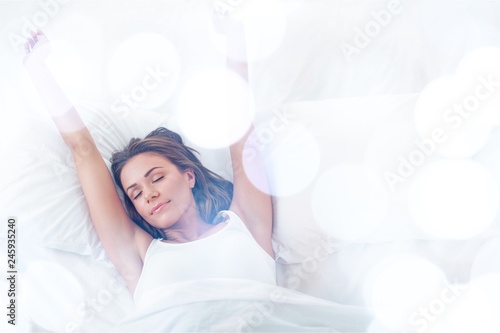 Young woman wakeup after sleeping on the white linen in bed at