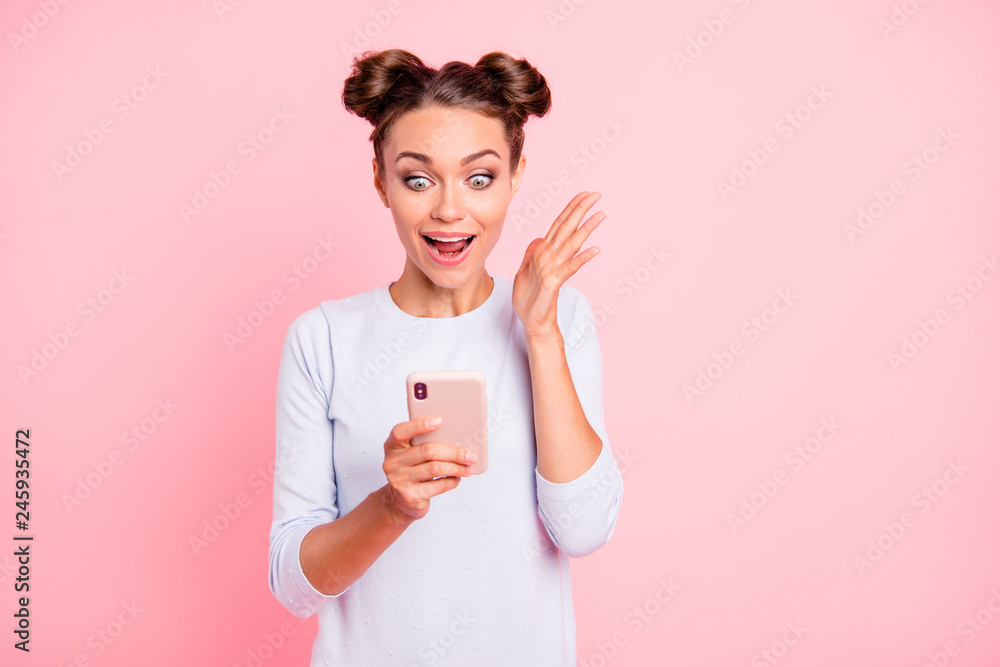 Portrait of her she nice fascinating attractive lovely sweet cheerful glad girl holding cell in hands reading winning notification isolated over pastel pink background Portrait of her she nice fascinating attractive lovely sweet cheerful glad girl holding cell in hands reading winning notification isolated over pastel pink background