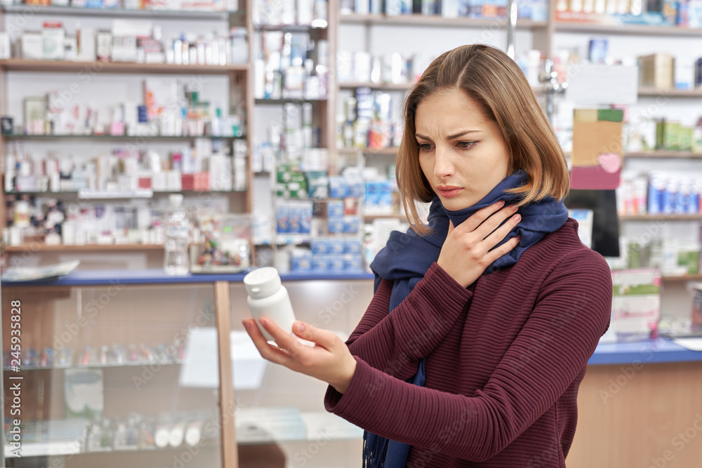 Customer holding botte mock with medicines in drugstore. Customer holding botte mock with medicines in drugstore.