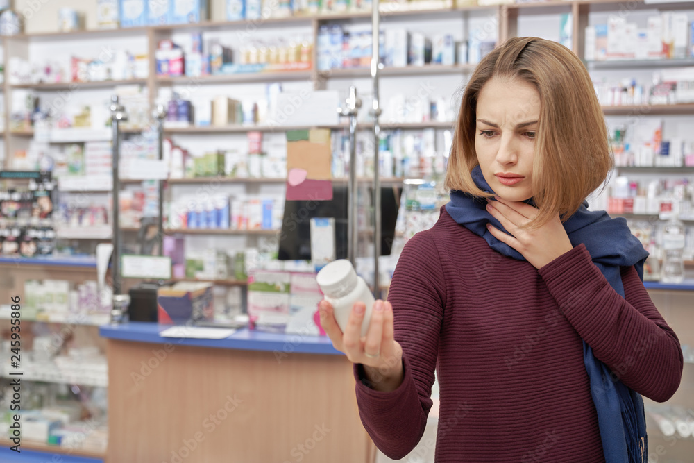 Ill woman holding bottle mock with medicines.