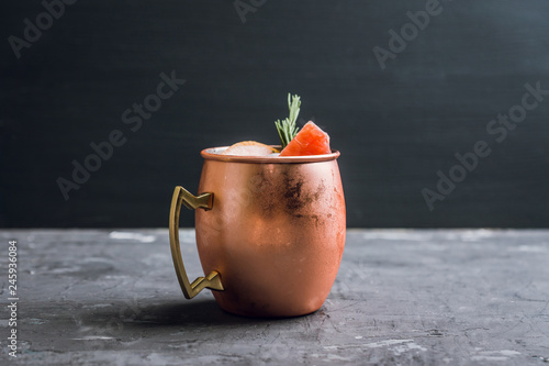 Canvas Print Grapefruit moscow mule in copper mug on the rustic background
