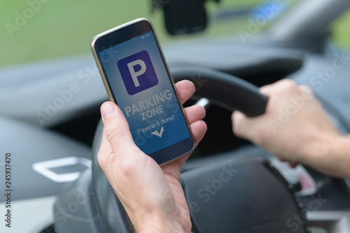 Driver using smartphone app to pay for parking © Monika Wisniewska