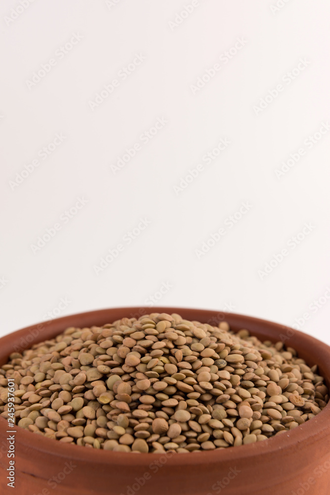 Obraz premium Yellow lentil in a bowl isolated on white background