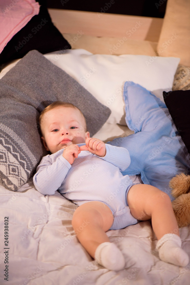 Little cutie boy smiling lying in bed before sleep. Childhood happiness. Little cutie boy smiling lying in bed before sleep. Childhood happiness.