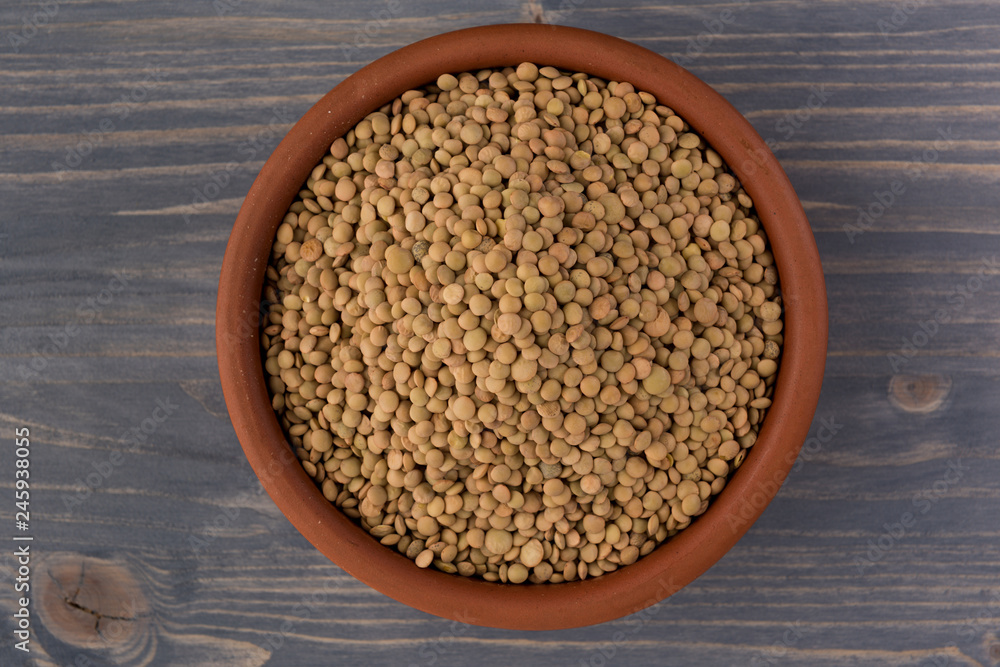 Yellow lentil in a bowl on wooden background Yellow lentil in a bowl on wooden background