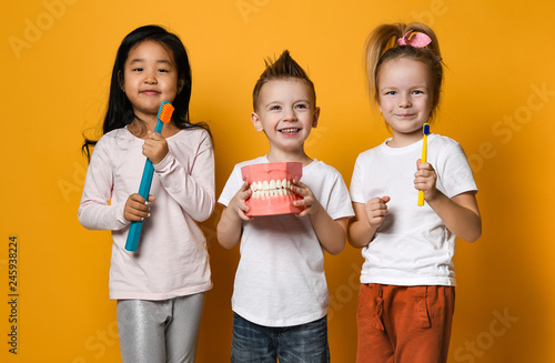 dental hygiene. happy little cute children with toothbrushes.