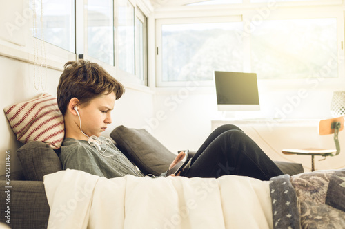 Photography Child watching a tablet at home. Boy looking at a tablet