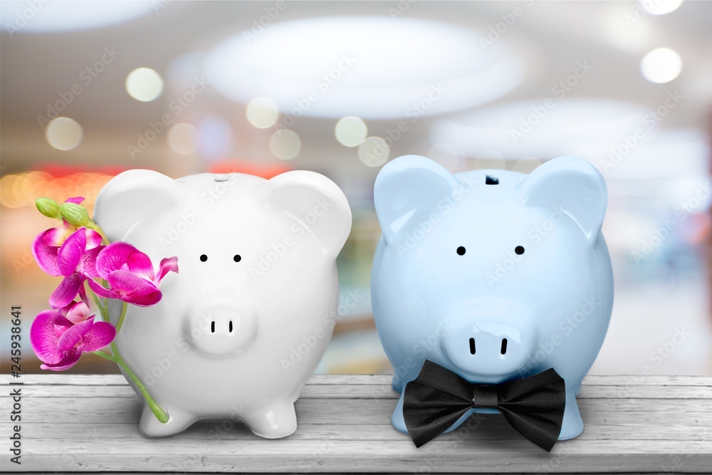 White and blue piggy banks on table on background White and blue piggy banks on table on background