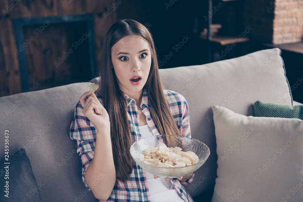 Fototapeta premium Pretty attractive funky curious lovely with long straight hairstyle she her lady holding bowl with crunchy crisps in hands watching television with opened mouth 