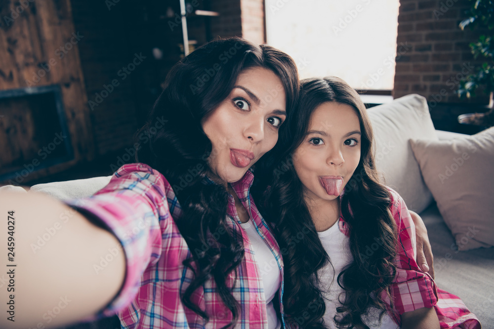 Self-portrait of nice-looking cute winsome adorable lovable lovely sweet attractive charming cheerful cheery people showing tongue sitting on divan in house Self-portrait of nice-looking cute winsome adorable lovable lovely sweet attractive charming cheerful cheery people showing tongue sitting on divan in house