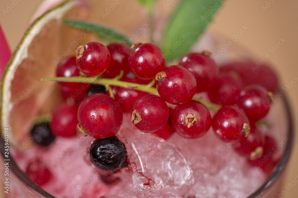 Tasty cold fresh drink lemonade with raspberry, mint, ice and lime in glass Tasty cold fresh drink lemonade with raspberry, mint, ice and lime in glass