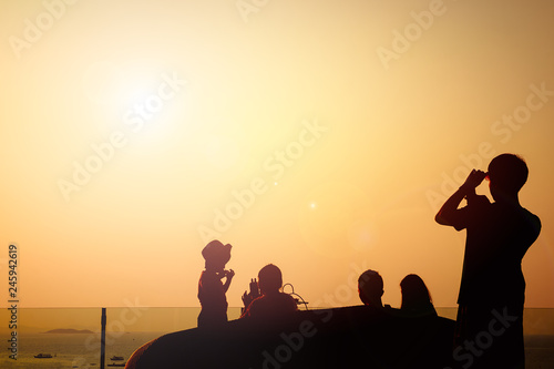 Silhouette image of the family The photo was taken on sea beach with sunset sky background