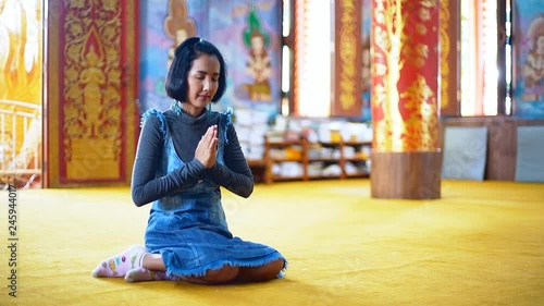 Asian Young Woman Pay Respect to the Buddha in the Temple.