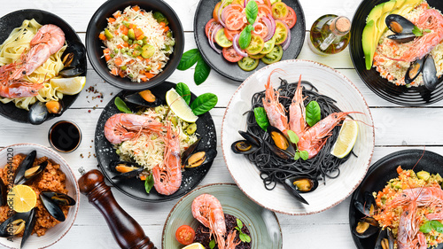 A set of seafood dishes on a white background. Pasta, bulgur, rice, couscous. Top view. Free space for your text.