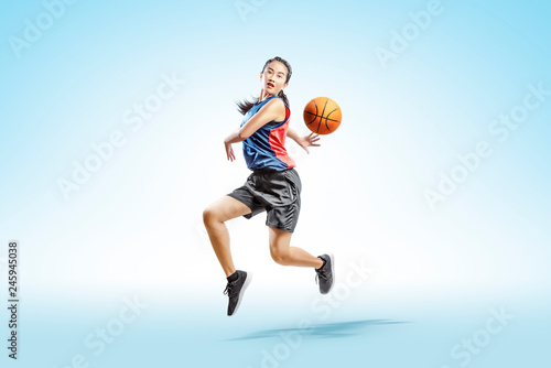 Attractive asian woman playing basketball © Leo Lintang