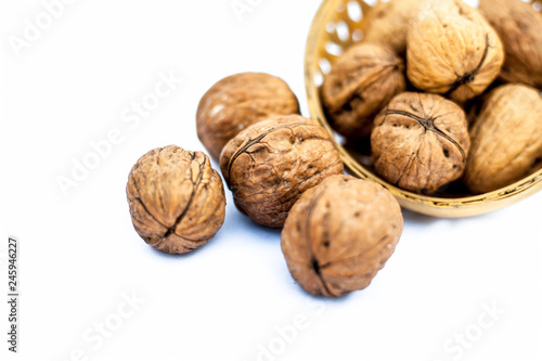 Close up of raw organic Walnut or Juglans or Akhrot or Akharot isolated on white in a hamper. photo