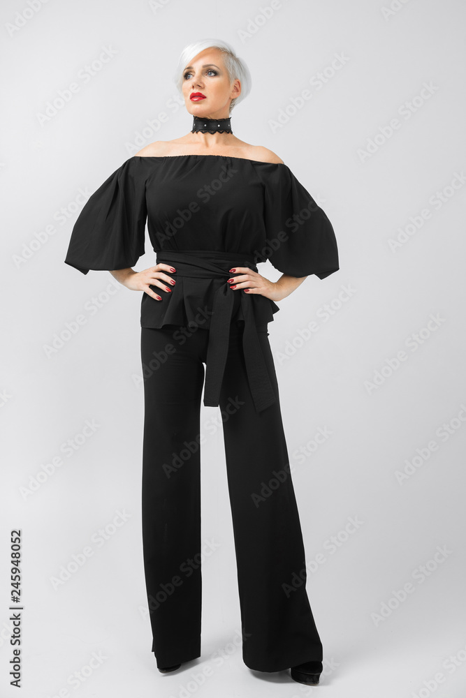 Fototapeta premium Vertical portrait of a woman in a suit in full height