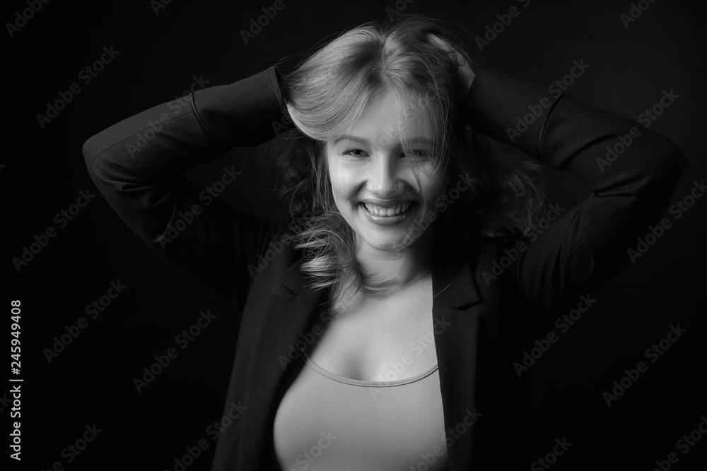 Young smiling woman with natural make-up in a black jacket. Young smiling woman with natural make-up in a black jacket.