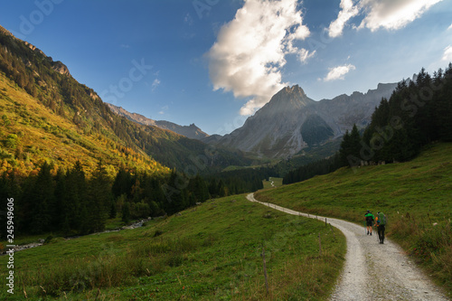 Tourists in the Alpine mountains in the French valleys with beautiful landscapes.