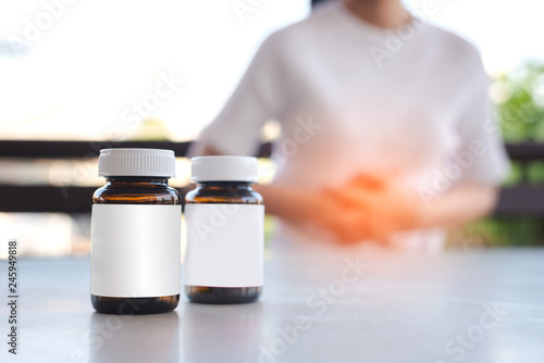 Two bottle on women stomachache background