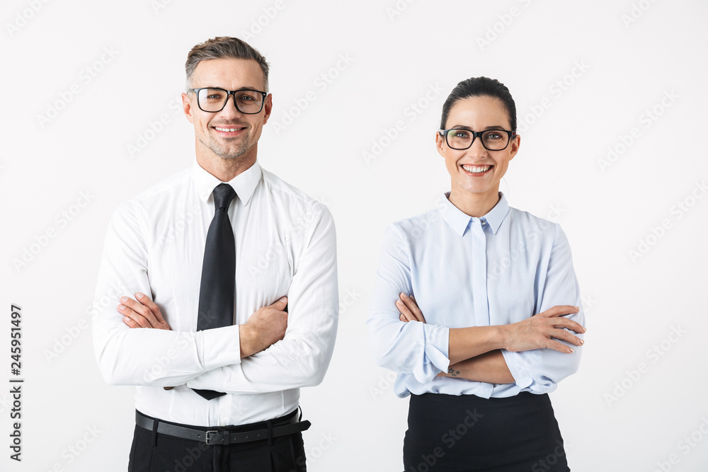 Young happy business colleagues couple isolated over white wall background. Young happy business colleagues couple isolated over white wall background.
