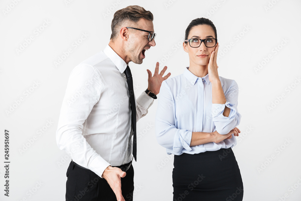 Displeased angry quarrel business colleagues couple isolated over white wall background. Displeased angry quarrel business colleagues couple isolated over white wall background.