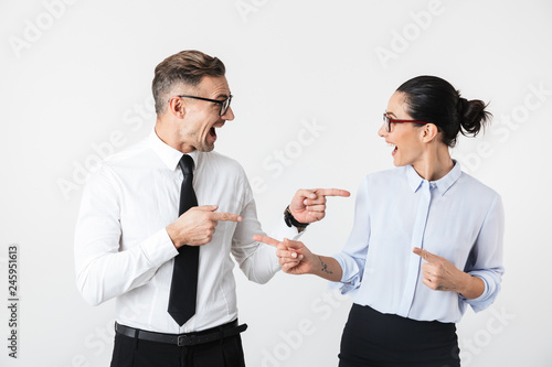 Young happy business colleagues couple isolated over white wall background.