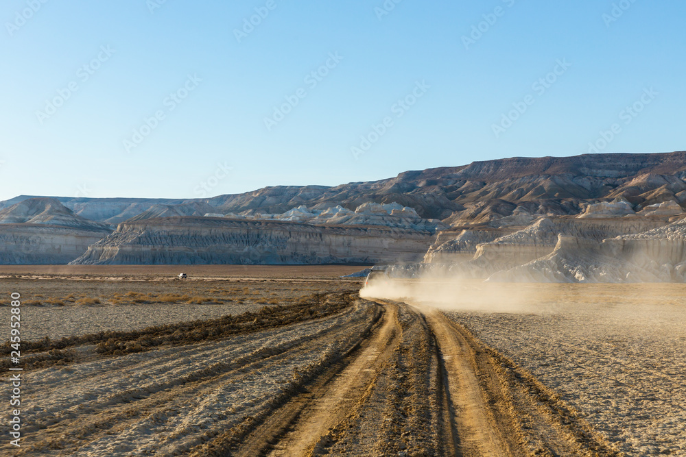 The brilliant steep chalk cliffs of the shore of Tuzbair salt dry lake in Mangystau, Kazakhstan