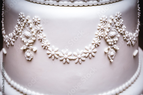 High confectionery cake decoration served at wedding receptions. Vintage style for weddings, birthdays.