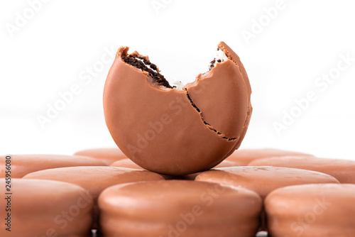 Chocolate biscuit sandwich in chocolate glaze on white background.