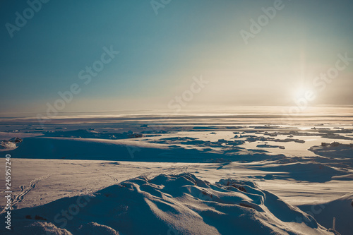 Bright sunrise panorama of the Antarctica. Overwhelming polar landscape. The winter sun over the snow covered frozen land. Ideal background for the collages and illustrations. Antarctic South Pole