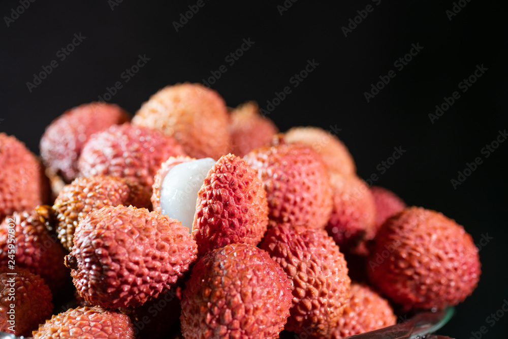 Tropical Lychee fruits, soapberry on rustic black table, background Tropical Lychee fruits, soapberry on rustic black table, background