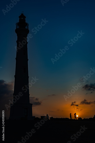 Aruba  California Lighthouse and people in silhouette at sunrise