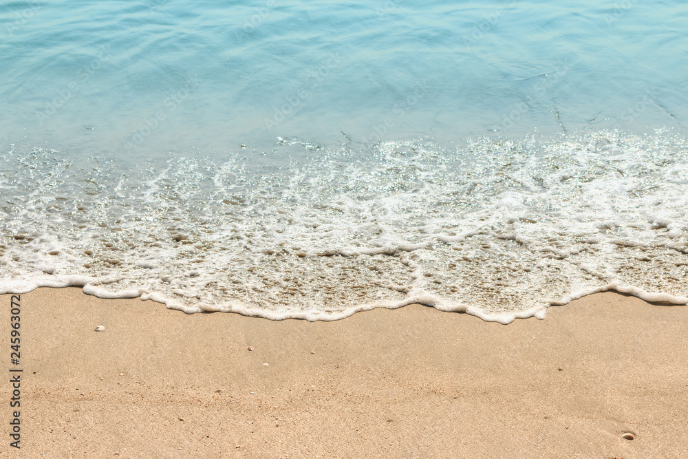 Beach sand with sea wave in summer day Beach sand with sea wave in summer day