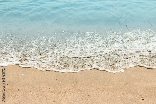 Beach sand with sea wave in summer day