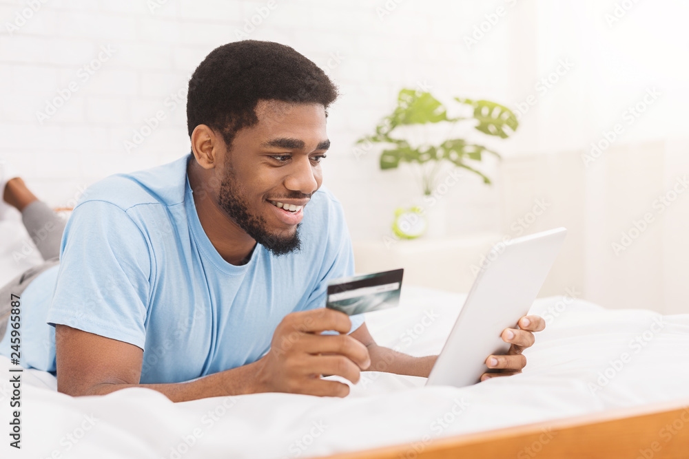 Man purchasing product online, using credit card to pay Man purchasing product online, using credit card to pay