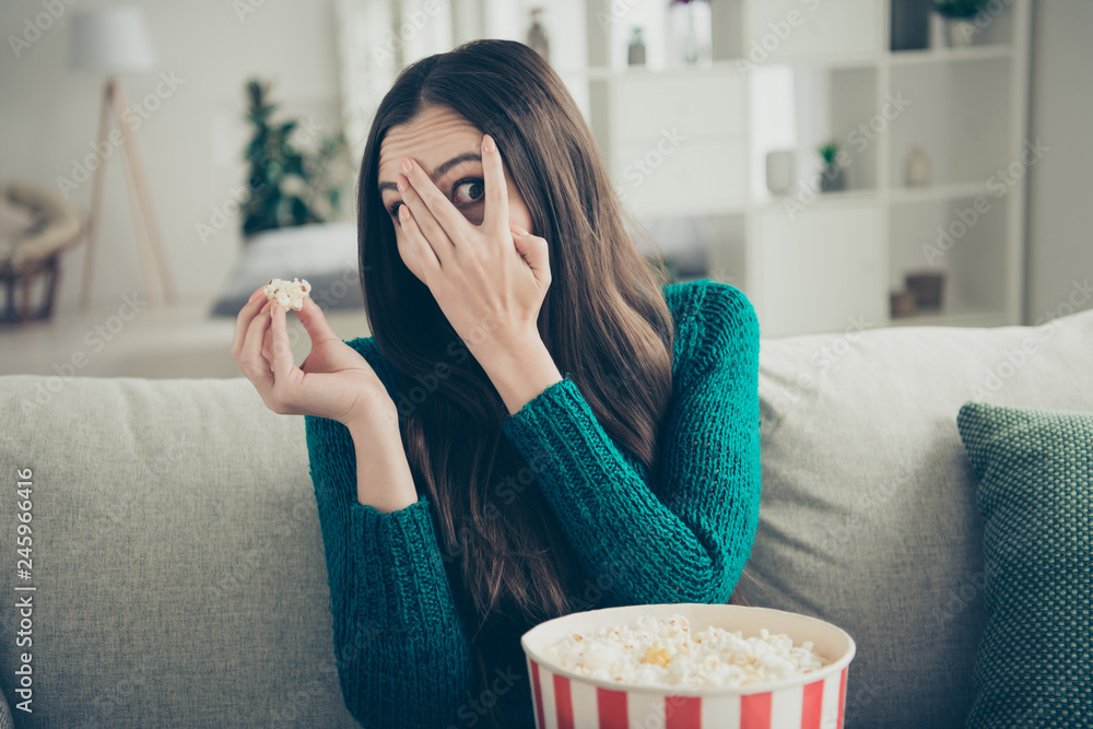 Scared beautiful with long straight brown hairstyle she her lady hiding face behind hand watching horror film alone in room Scared beautiful with long straight brown hairstyle she her lady hiding face behind hand watching horror film alone in room