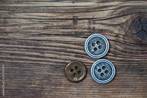 set of vintage buttons on wooden boards aged antique table. instagram image filter retro style