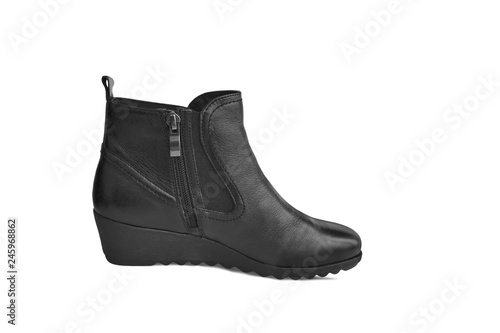 Single short black leather women’s boot isolated on white background. Short demi-season shoes with zipper, fashion and shopping concept