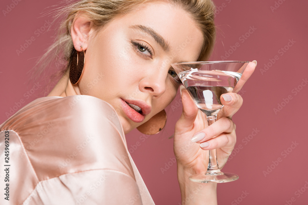 beautiful sensual young woman in silk robe holding cocktail glass, isolated on pink beautiful sensual young woman in silk robe holding cocktail glass, isolated on pink