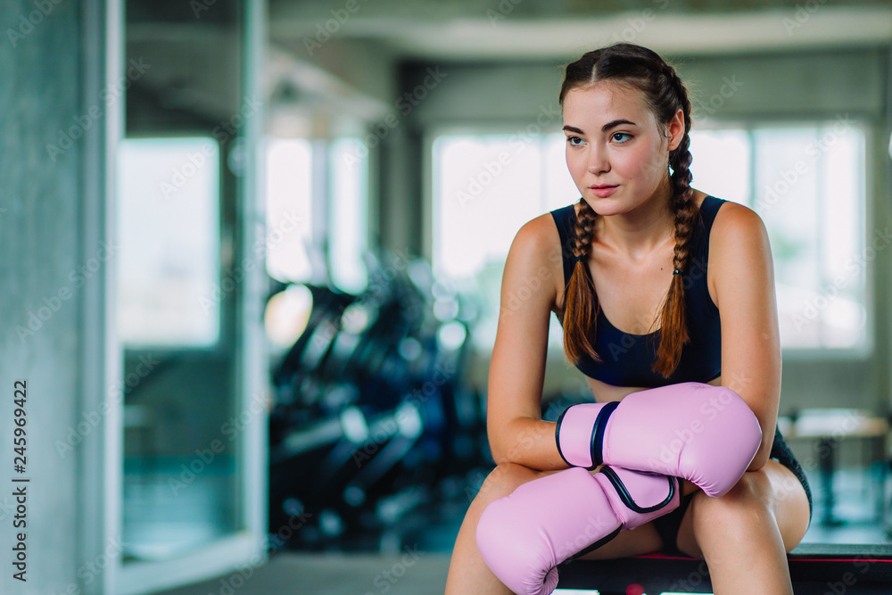 Fit beautiful young woman muay thai boxer exercise class in a gym. Healthy, sport, lifestyle, Fitness, workout concept. With copy space.