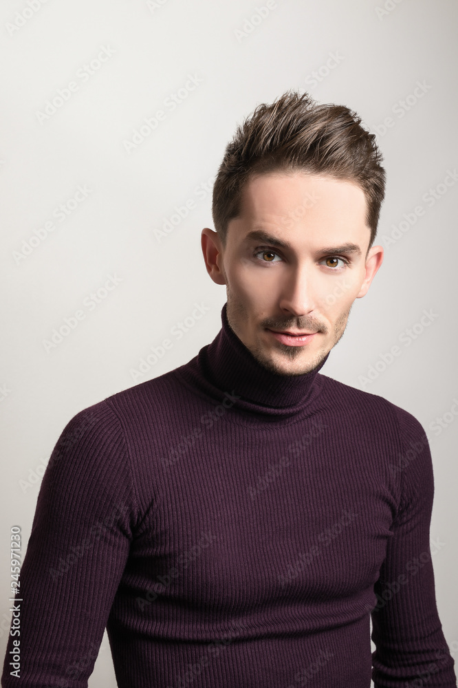 Handsome young elegant man in violet golf. Handsome young elegant man in violet golf.