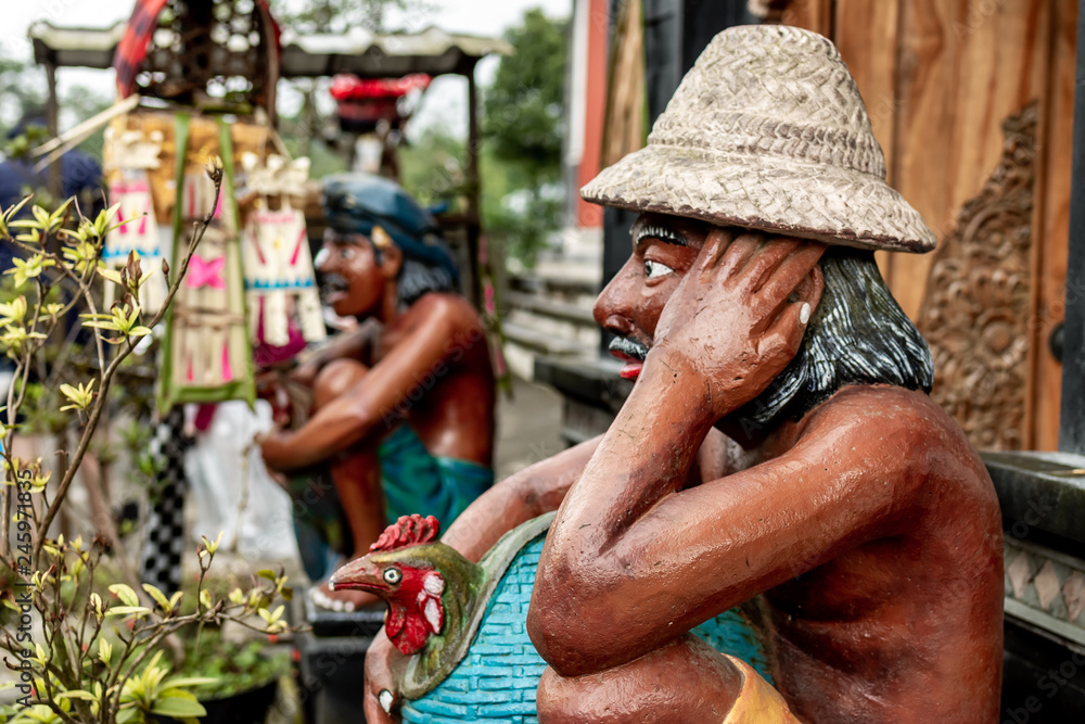 Balinese statue of rice field worker, tropical island of Bali, Indonesia. Balinese statue of rice field worker, tropical island of Bali, Indonesia.