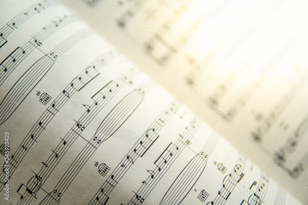 Close up music note on sheet. Musical notes on old vintage paper. Music playing and entertainment concepts Close up music note on sheet. Musical notes on old vintage paper. Music playing and entertainment concepts
