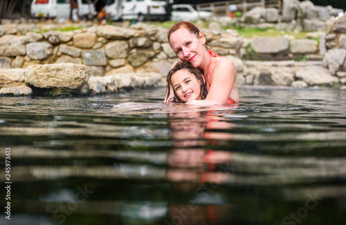 Fototapeta Naklejka Na Ścianę i Meble -  Mother and daughter relaxing in natural thermal water roman spa.