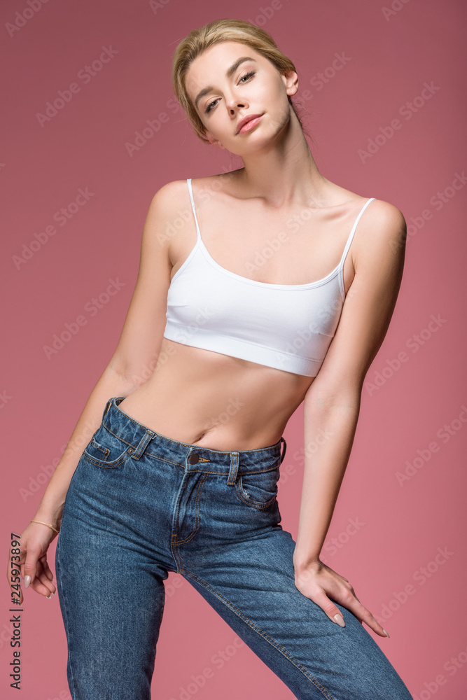 beautiful slim woman posing in white bra, isolated on pink beautiful slim woman posing in white bra, isolated on pink
