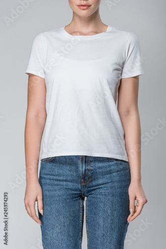 front view of girl posing in white t-shirt with copy space, isolated on grey