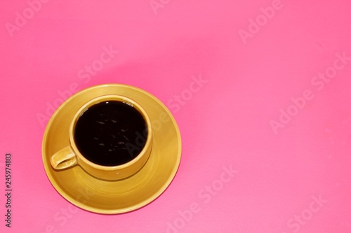 Coffee cup on pink background.